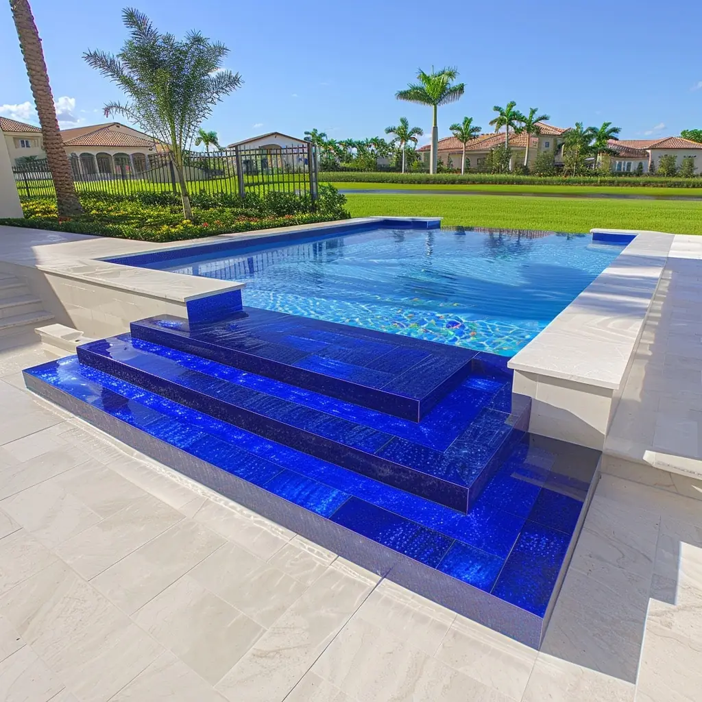 Pool with blue glass-tile entry steps and a white deck