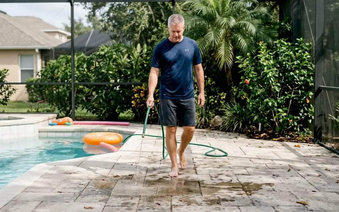 Homeowner maintaining textured paver pool deck