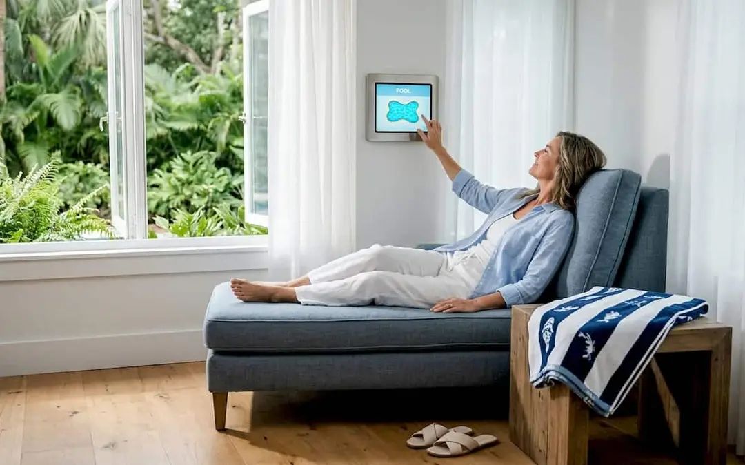 Homeowner uses pool automation panel in living room