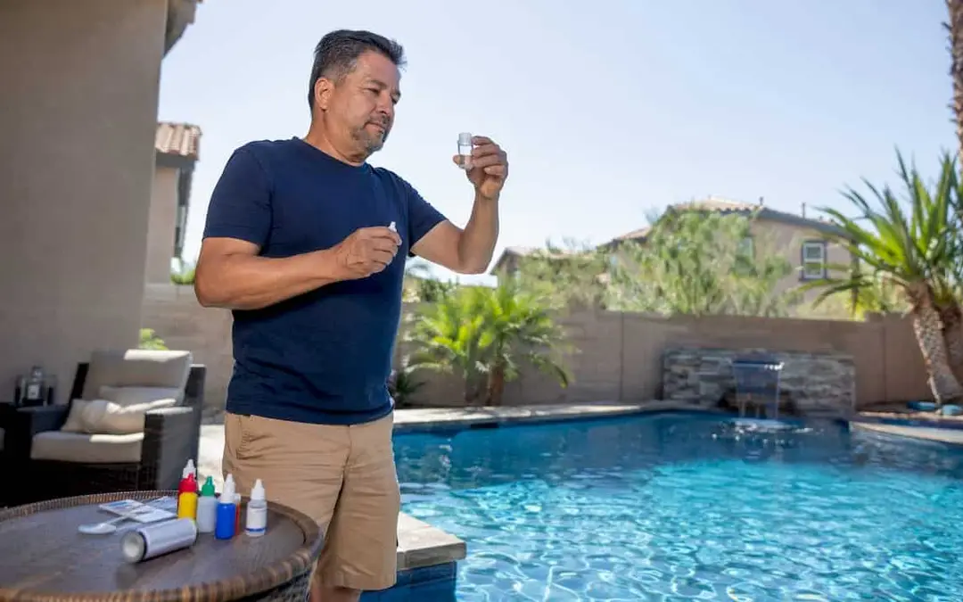 Homeowner testing swimming pool water