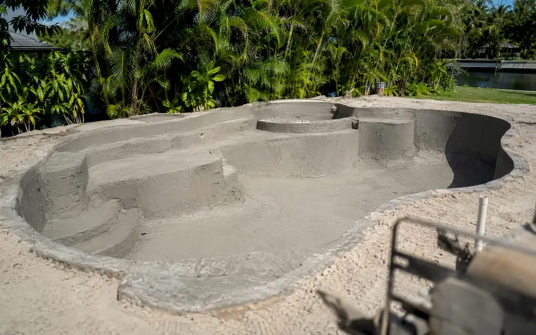 Partially constructed custom concrete pool in Florida backyard