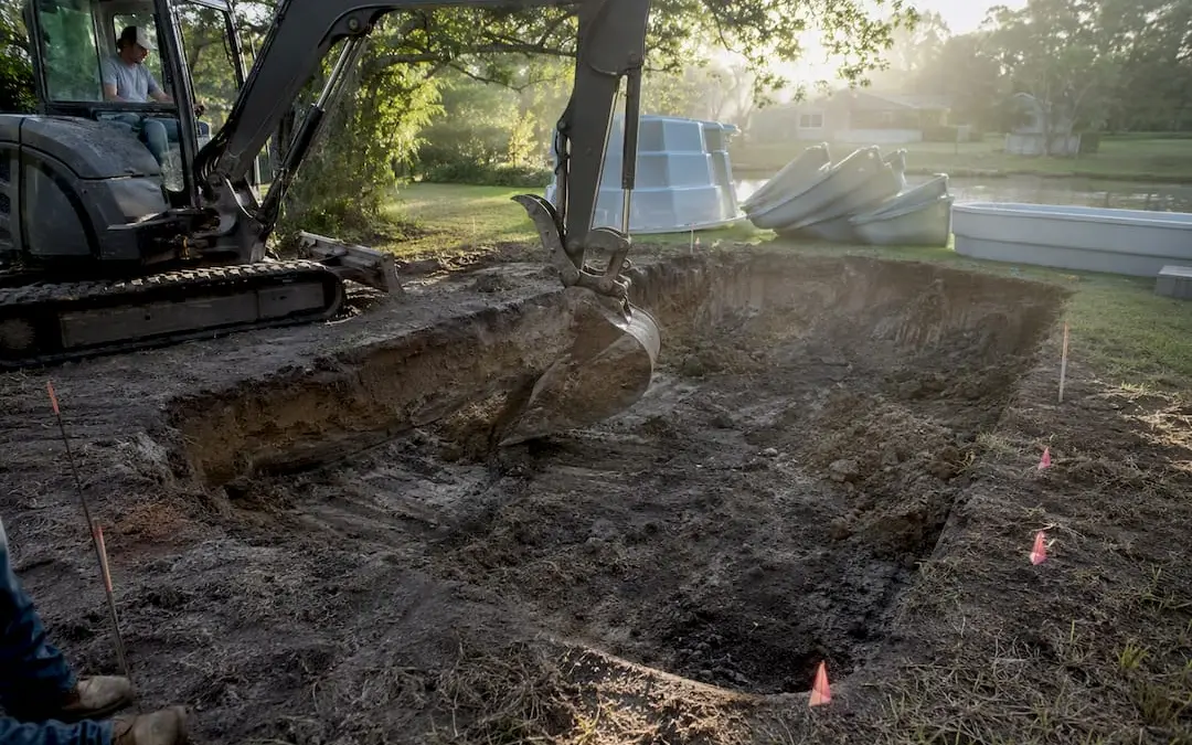 Backyard fiberglass pool excavation in progress