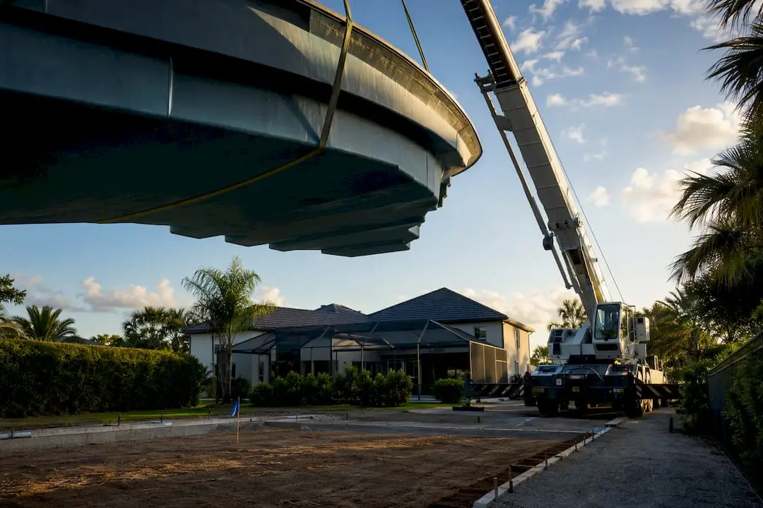 Crane positioning fiberglass pool shell
